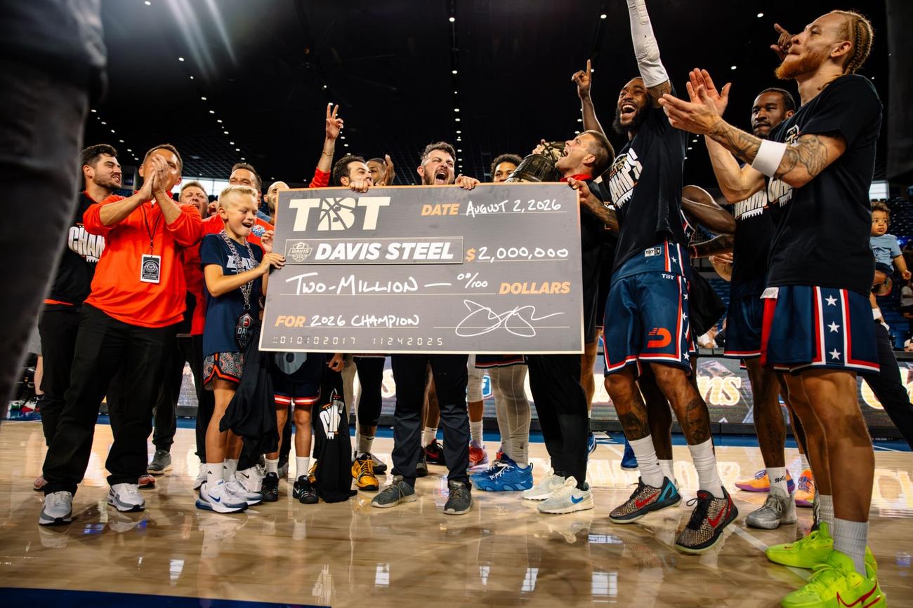 The team celebrating around the $2 million check after the 2026 championship
