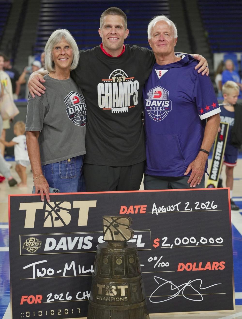 Matt with his mom and dad and the championship check and trophy after the 2026 championship