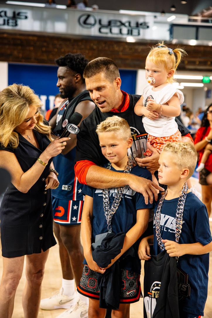 Matt with his boys and daughter during a postgame TV interview