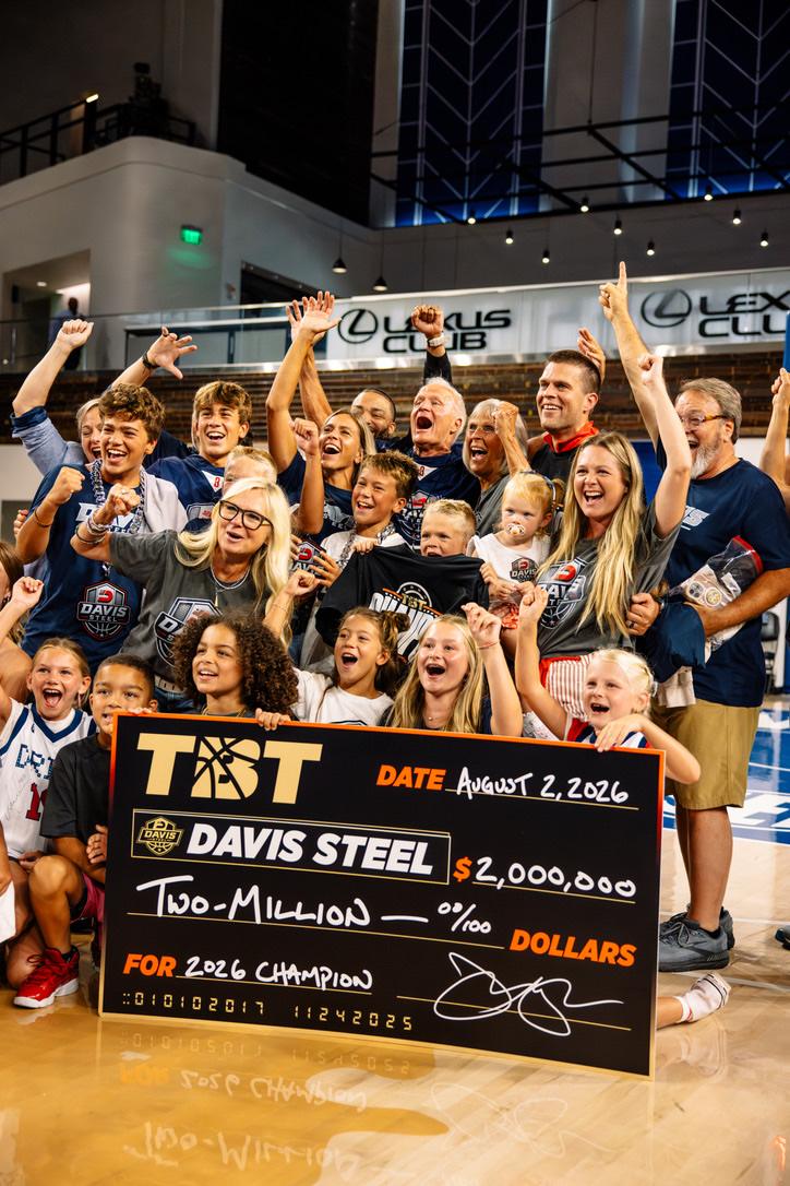 Family and friends celebrating around the championship check